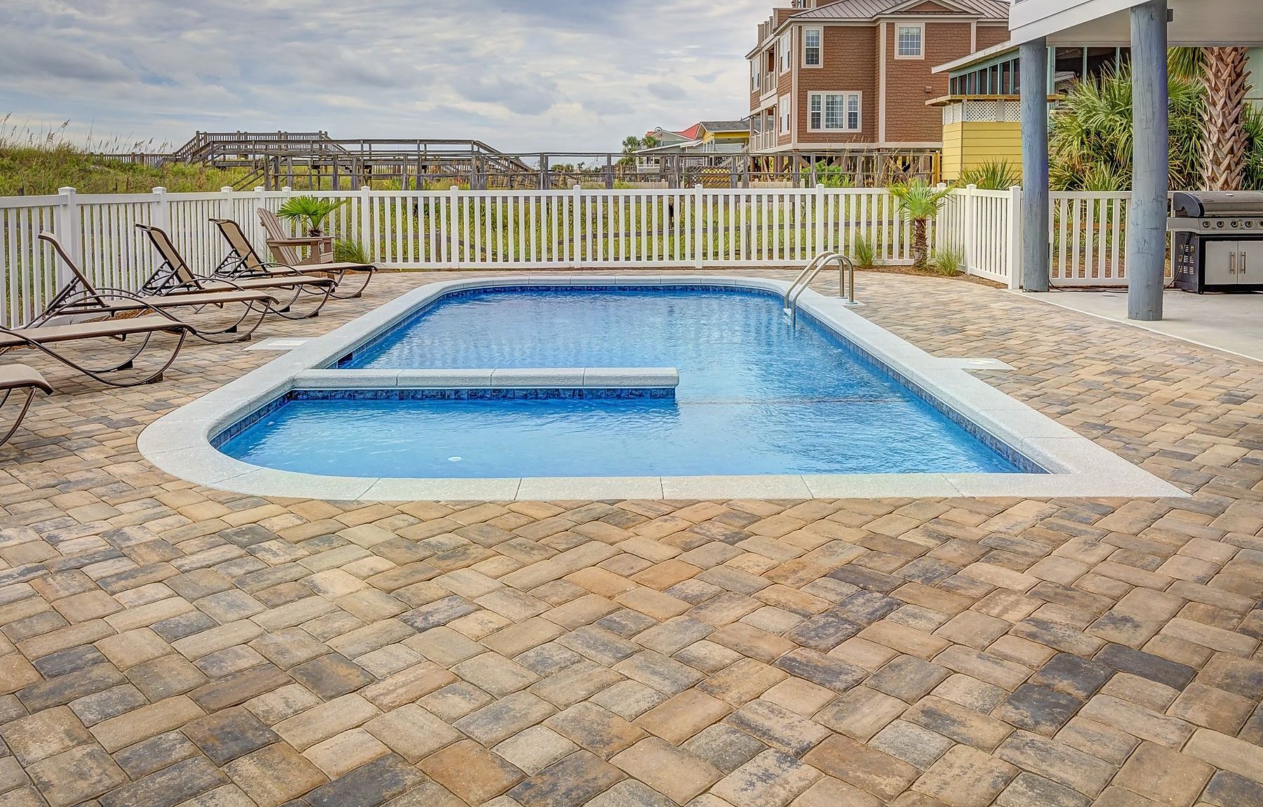 A custom backyard pool with paver decking on the Mississippi Gulf Coast